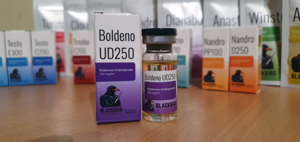 A product display of Boldeno UD250 (Boldenone Undecylenate 250 mg/ml) on a wooden tabletop.