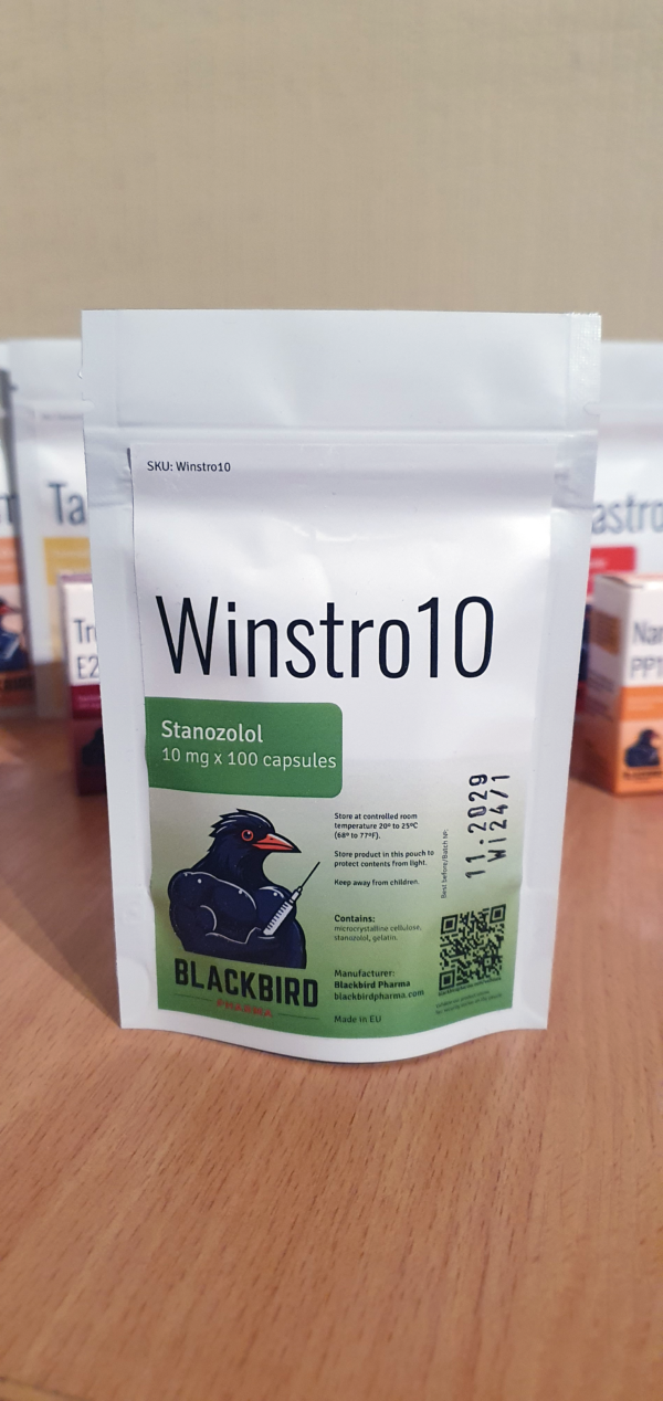 A product display of Winstro10 (Stanozolol 10 mg/capsule) on a wooden tabletop.